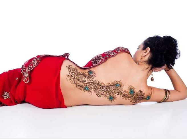 Peacock feathers back tattoo