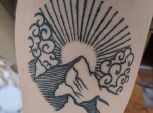 Sun over mountain tattoo reading